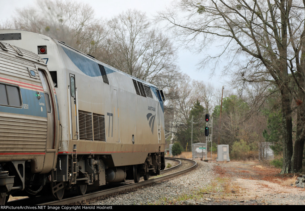 AMTK 77 leads train P080-26 away from the station